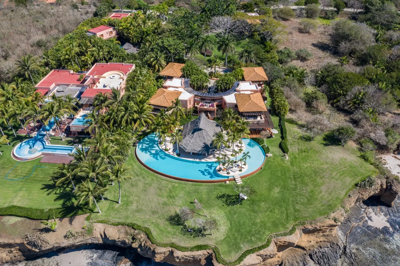 Aerial view of the gardens, the pool and the palapa on the point