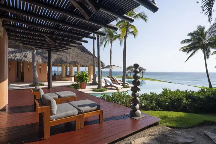 Master Suite 1: the private terrace with daybeds, steps from the infinity pool