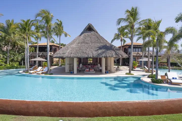 The palapa across the pool, palms on every side