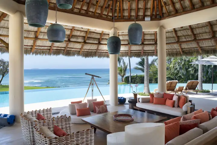 The palapa lounge in daylight, a telescope trained on the bay