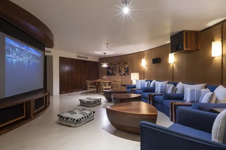 The private cinema with its deep blue sofas and big screen