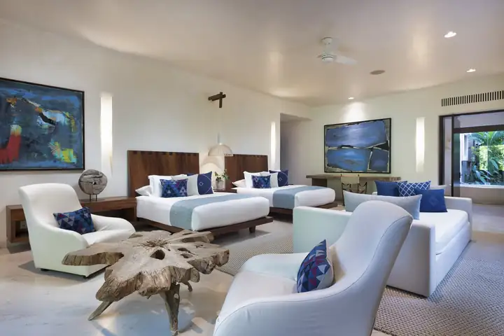 Guest Suite 4: the main-level suite with two beds and a sitting area