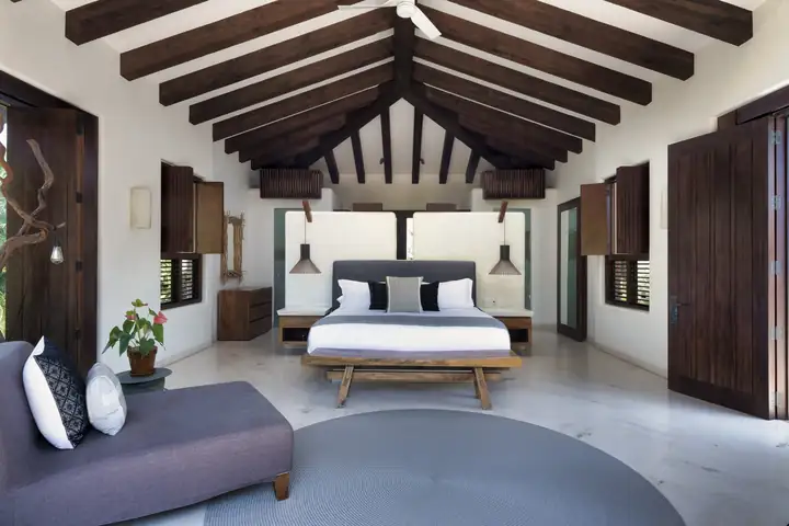 Guest Suite 6: the bedroom under its vaulted, beamed ceiling