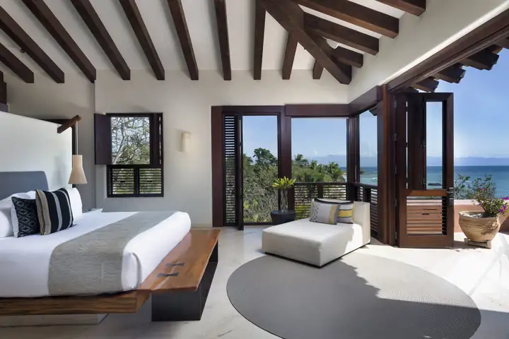 Suite 7: the upper-level king bedroom opening to a sea-view terrace